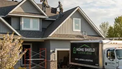 Vinyl siding repair specialists working on storm-damaged home exterior in Fort Collins, CO